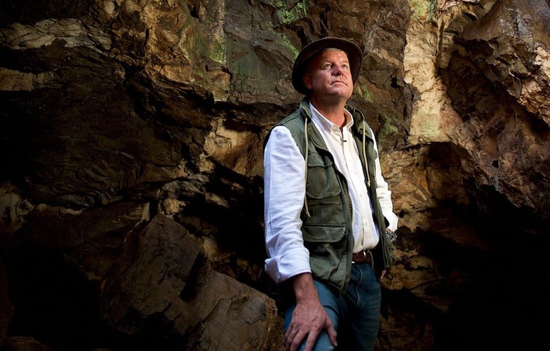 Forsker Lee Berger står inne i en grotte